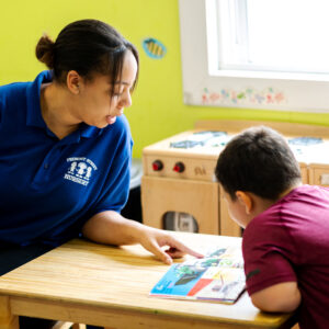 Local Care & Family Day Homes Woman teaching young boy.